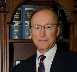 John E. Suthers